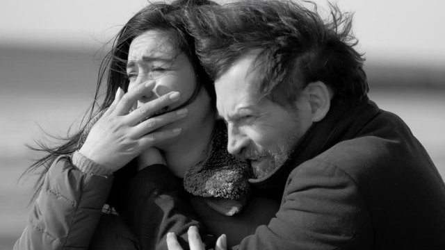 Desperate couple crying because of loss death of parent