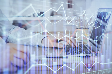 Multi exposure of stock market chart with man working on computer on background. Concept of financial analysis.