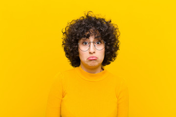 young pretty afro woman feeling sad and stressed, upset because of a bad surprise, with a negative,...