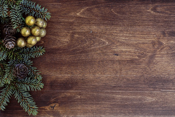 New Year's background. Spruce branches on a wooden table. Ornaments for the New Year tree. Christmas concept.
