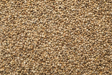 Organic hemp seeds as background, top view