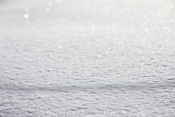 Obraz premium The texture of the snow. Winter rainfall. Tracks on a snowy road after a snowfall.