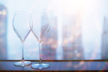 Cocktail glasses on the windowsill by the glass
