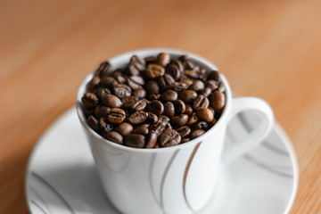 white cup full of coffee beans