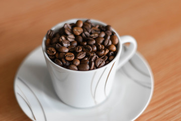 white cup full of coffee beans