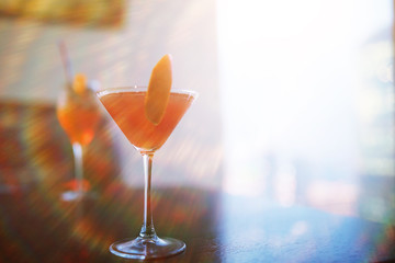 Cocktail glasses on the windowsill by the glass