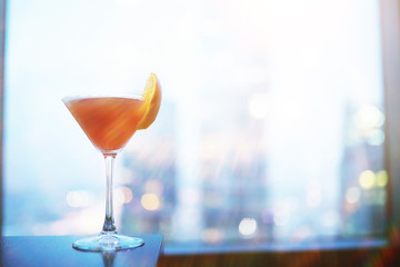 Cocktail glasses on the windowsill by the glass