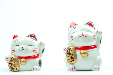 Lucky cat statue for Japanese isolated on a white background, Holds a gold medal in Japanese that translates into prosperity and good fortune.