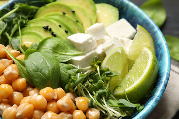 Delicious avocado salad with chickpea in bowl, closeup