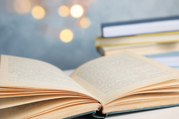 Open hardcover book on white table, closeup