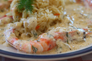 Paella with shrimp and white sauce on a plate