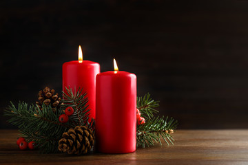 Beautiful composition with candles and Christmas decor on wooden table