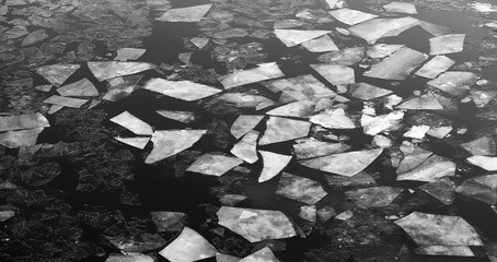 Drifting on the river. Fragments of ice float on river.