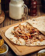 chicken doner in lavash on wooden board