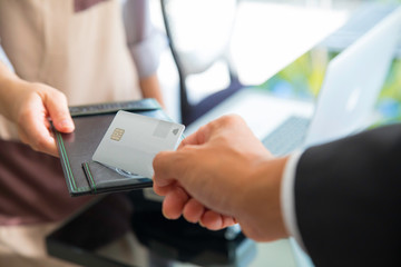  close up of customer giving credit card to waiter in restaurant