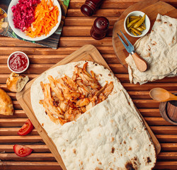 fried chicken doner in lavash on wooden board