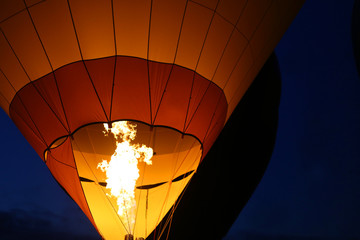 Flame on a hot air balloon at night