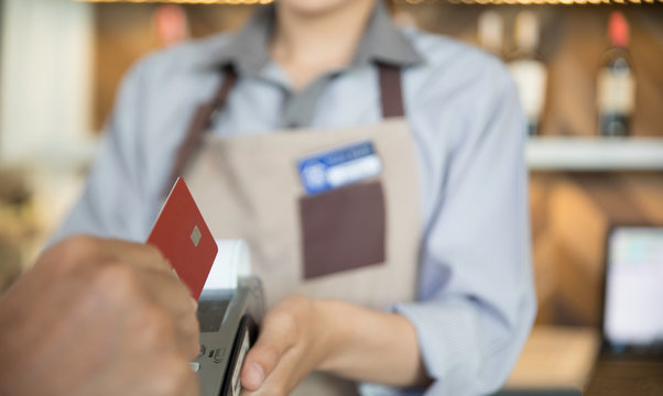 the man paying the bill by credit card at bar, shopping and retail concept