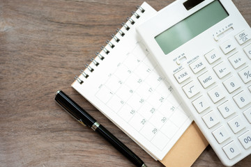 Keypad TAX button For tax calculation. Easy to calculate. on White calculator wood background using as background business concept and Education concept with copy spaces for your text or design.