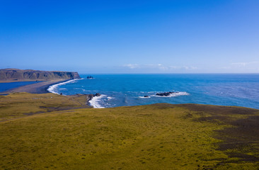 Reynisfjara Black Sand Beach, South Coast Iceland. View from dyrolaey. Panorama. Afternoon. Aerial drone shot, september 2019
