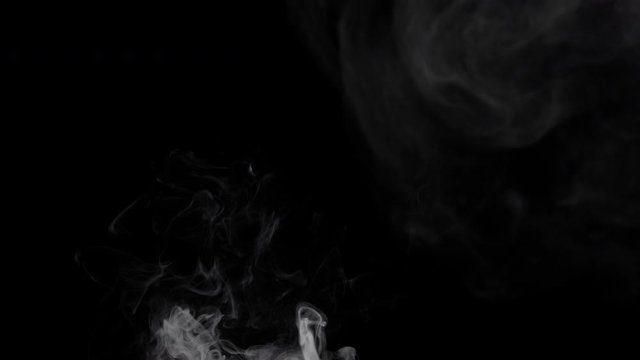 Smoke billowing over a black background.