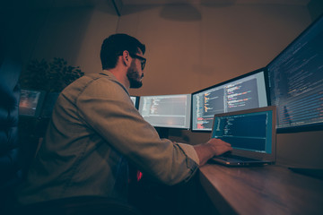 Low below angle view photo of it-specialist developing C code improving system of cyber security of...