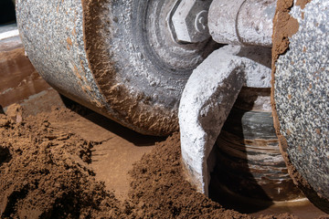 millstone of industrial melanger grind cocoa in the process of making chocolate