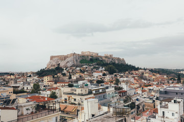 Fototapeta na wymiar Acropolis and old city in Athens in a cloudy day