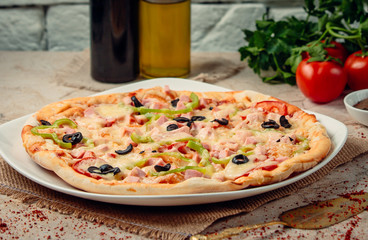 pepperoni pizza with vegetables on the table