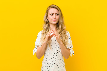 young blonde woman scheming and conspiring, thinking devious tricks and cheats, cunning and...
