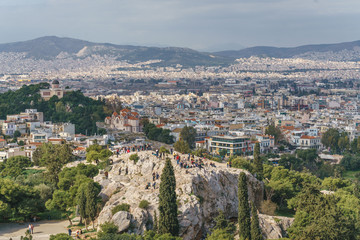 Fototapeta na wymiar Panoramic view of the Areopagus hill and Athens City, an Ancient Rock Observation Deck in the Acropolis of Athens, Greece