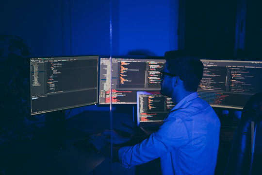 Profile side view of his he nice senior middle top specialist brunet guy providing service outsource tech solving problem debug report quality testing qa in dark blue room workplace station indoors