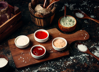 various sauces on wooden board