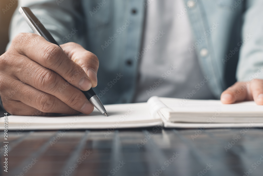 Poster man writing on notebook