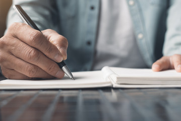 Man writing on notebook