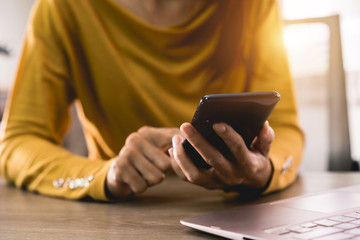Women hands holding Mobile Phone with blank screen and Credit Card on office desk and using mobile phone for Online Shopping, Internet Banking, Online Trading, E Commerce Concept. with clipping path