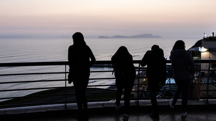 silhoette of people watching water show in lima peru