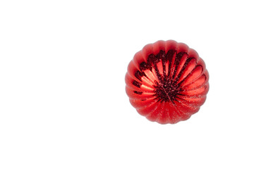 Old, red, textured ball in artificial snow on a white background
