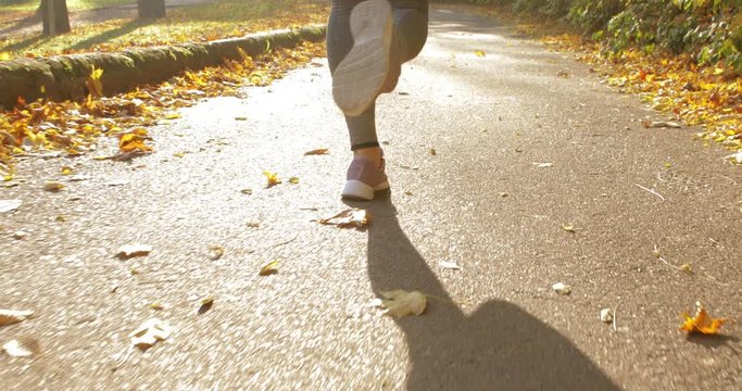 girl makes a run on the road. training. jogging. close up view feets