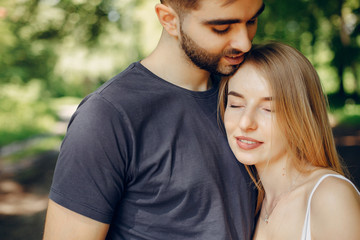 Obraz premium Couple in a forest. Beautiful blonde with her boyfriend