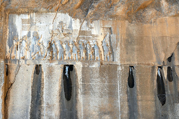 Behistun Inscription and large rock relief on a cliff at Mount Behistun in Kermanshah Province of...
