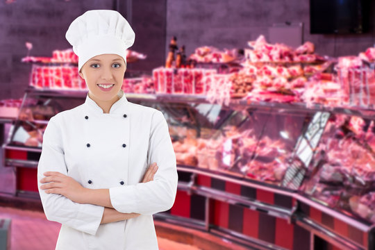portrait of cheerful female butcher, shopkeeper or cook in the market