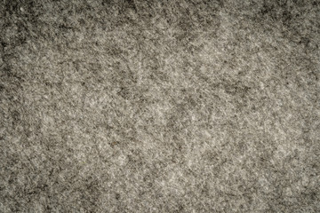 Grey heather knitted fabric made of synthetic fibres textured background. Grey knitted fabric texture. Background with delicate striped pattern