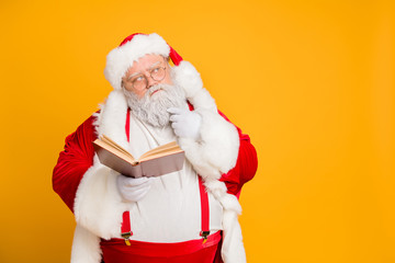 Who choose. Portrait of serious thoughtful santa claus hold paper book of good bad kids decide whom...