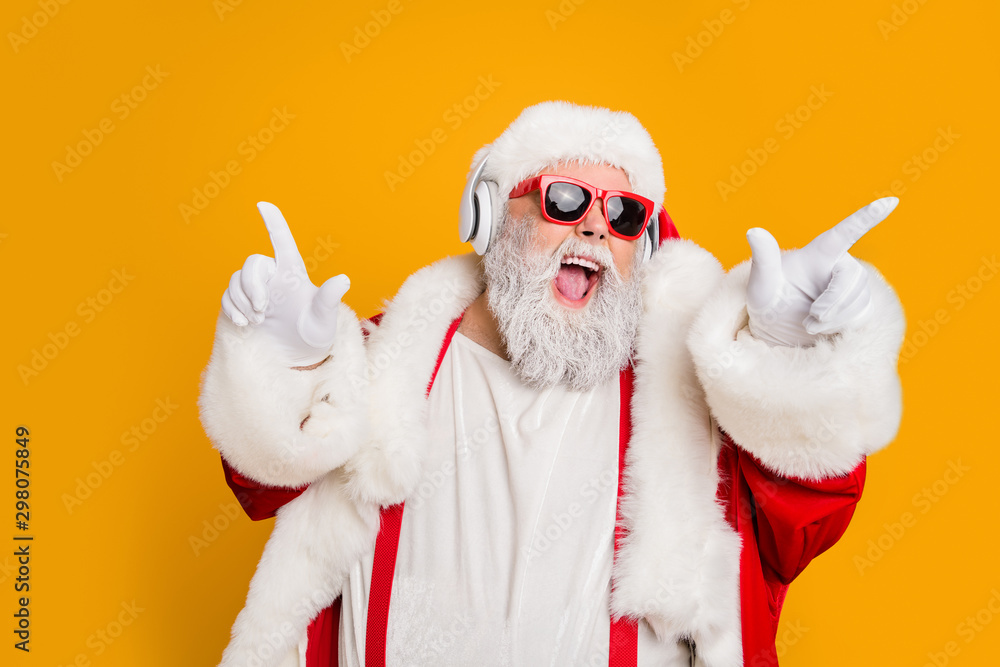 Wall mural Nightclub invite on christmas party celebration funky crazy santa claus dj in white headset sing song sound melody listen music dance wear stylish x-mas hat suspenders isolated yellow color background