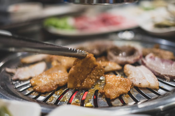 Pork grill on hot coals, Korean or Japanese BBQ Yakiniku style. (vintage tone)
