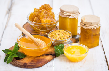 Fresh honey in the jars, with honeycomb and bee pollen