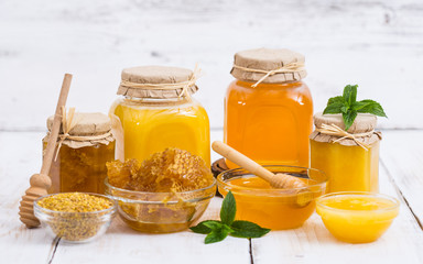 Fresh honey in the jars, with honeycomb and bee pollen