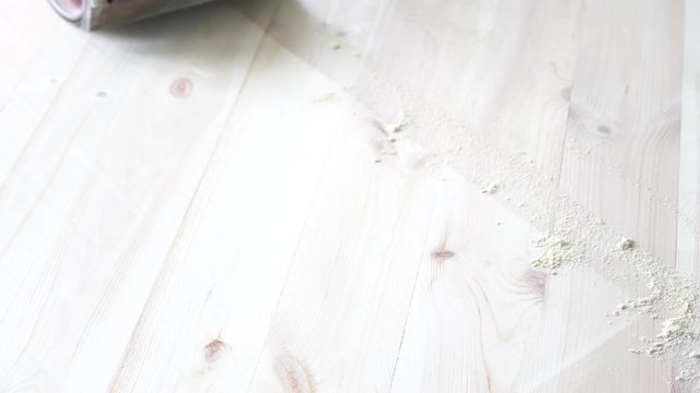 sanding a wooden floor with a grinder