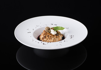 salad puree in a plate on a black background